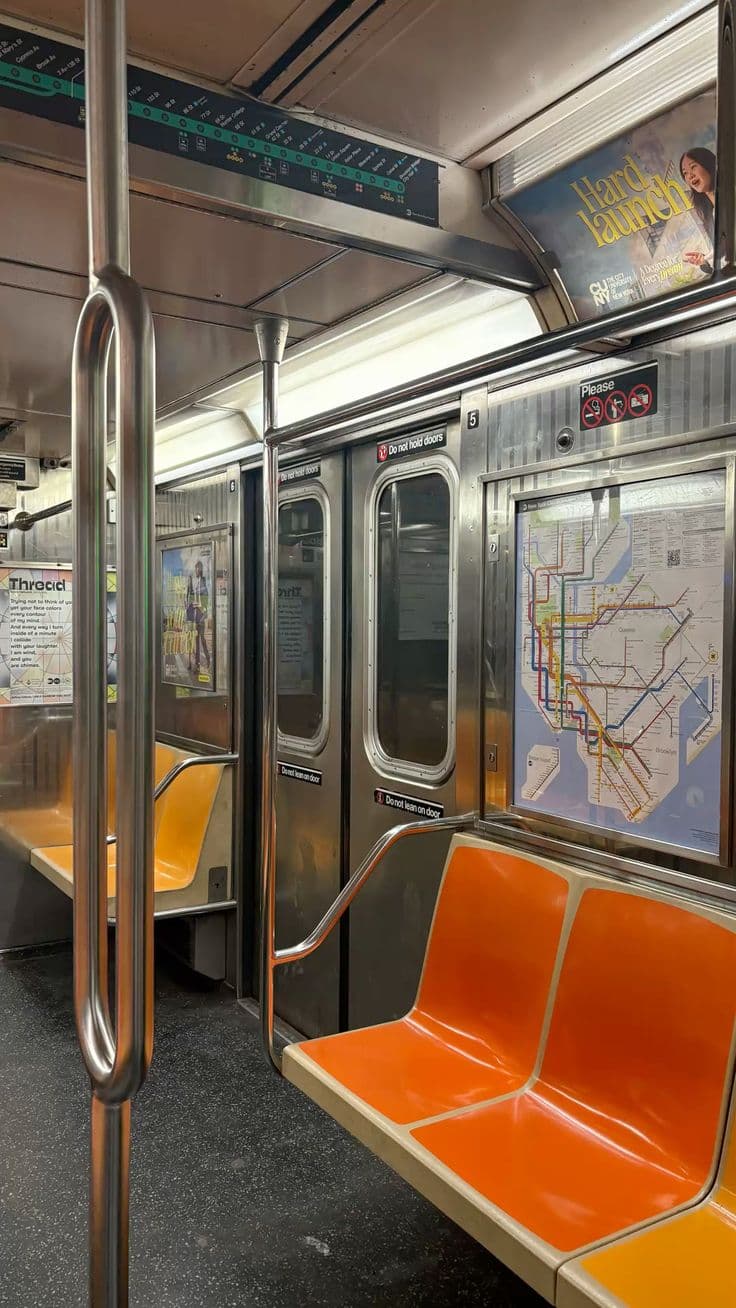 Empty subway car with orange seats
